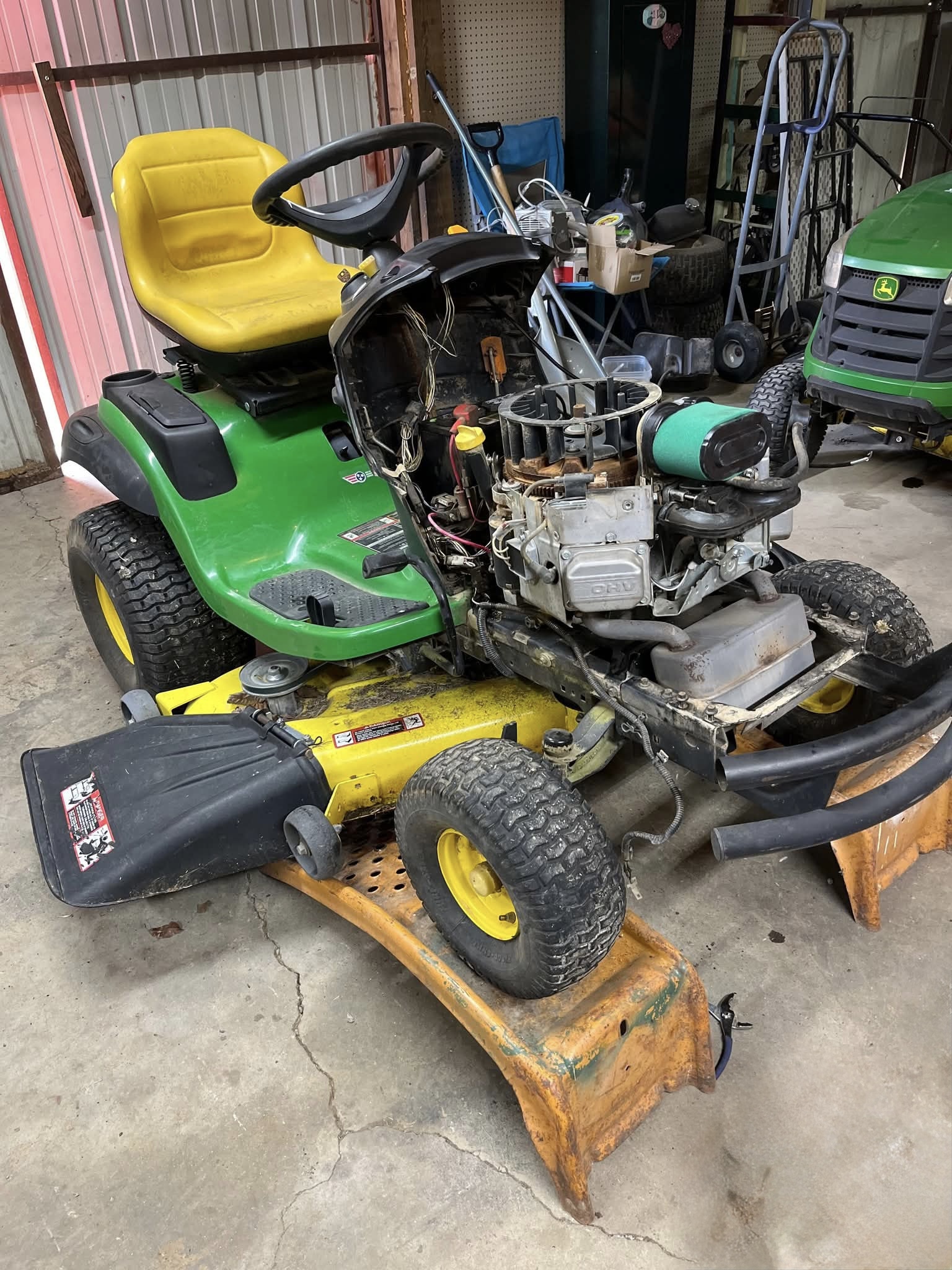 Lawn tractor on ramps being serviced at Sandy River Small Engine Repair